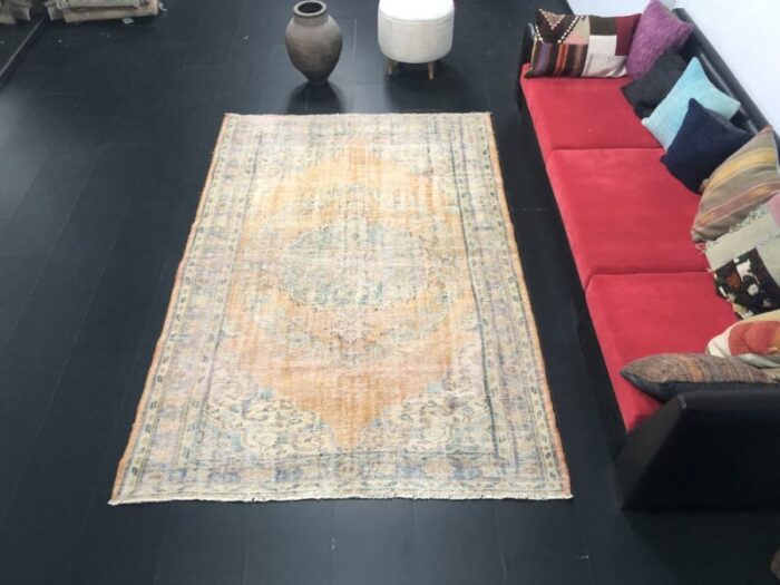 vintage orange faded oushak wool rug 1